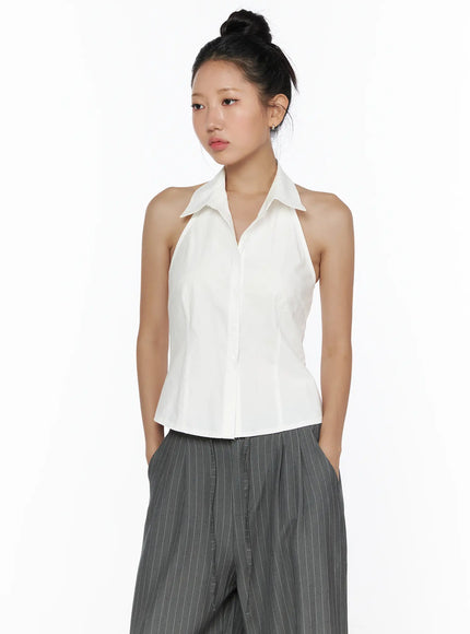Halter Sleeveless Shirt CL510 White front shot on model, halter collar, button-down placket, fitted waist, styled with grey pinstripe wide-leg pants