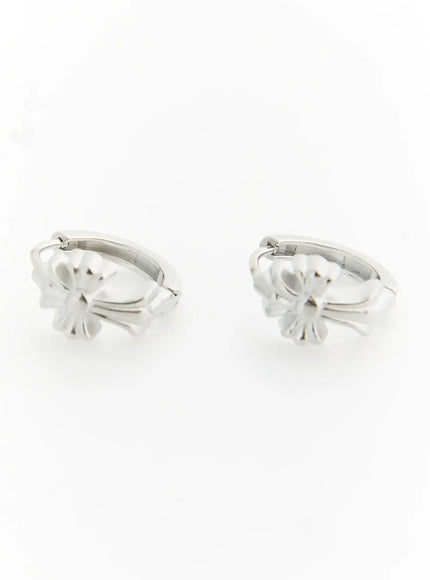 LEWKIN Haven Bold Heart Earrings IL522 silver pair front view showing floral cross motif hoop design with polished metallic finish on white background