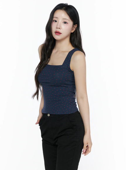 Heart Polka Dot Tank Top IU525 Navy side view on model showing square neckline, wide straps, and scattered red heart print on navy ribbed knit