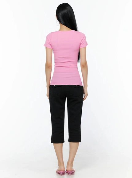Henley Graphic Tee IL509 Pink back shot model standing showing clean plain back of ribbed fitted tee with short sleeves paired with black capri pants