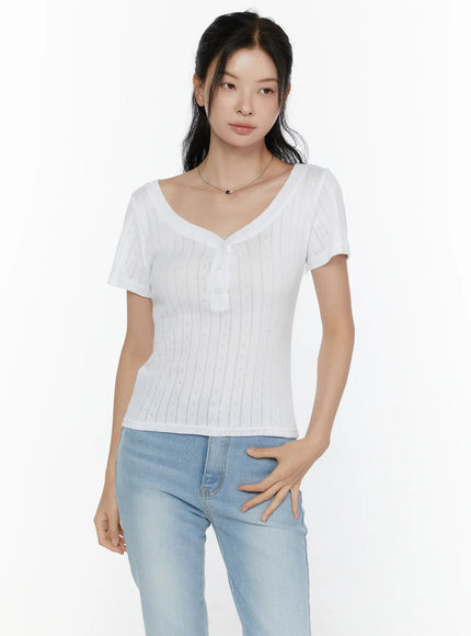 Henley Short Sleeve Tee CL521 White front shot model upper-body crop showing V-neckline button placket and pointelle diamond knit texture paired with light blue jeans