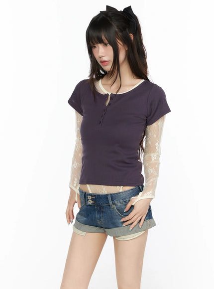 Henley Short Sleeve Tee CL523 Purple three-quarter front view on model looking downward, fitted ribbed crop tee with cream lace sleeve underlay styled with denim shorts