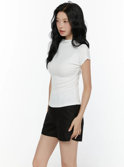 High Neck Cap Sleeve Top CL521 White side angle view on model showing slim ribbed silhouette and cap sleeve structure with black shorts