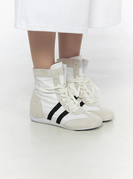 High Top Sneakers CL527 White three-quarter close-up on model showing side profile, suede ankle strap tab and black grosgrain stripe