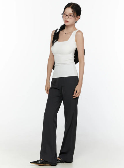 High-Waist Bootcut Tailored Pants CL520 Black three-quarter front styling shot on model in white tank with black bow accessory and flat shoes