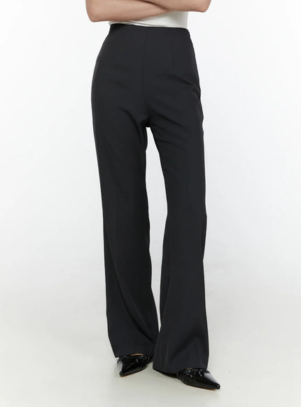 High-Waist Bootcut Tailored Pants CL520 Black three-quarter side view on model with arms crossed showing tailored waistband and bootcut flare