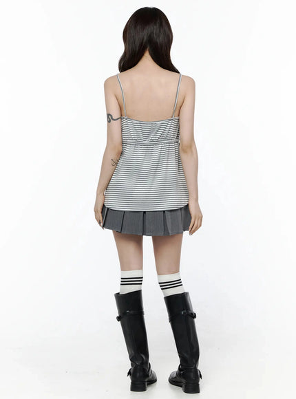 High-Waist Bow Pleated Skirt IL506 Dark gray back view on model in striped cami top and black knee-high boots, showing full pleated back and high waistband