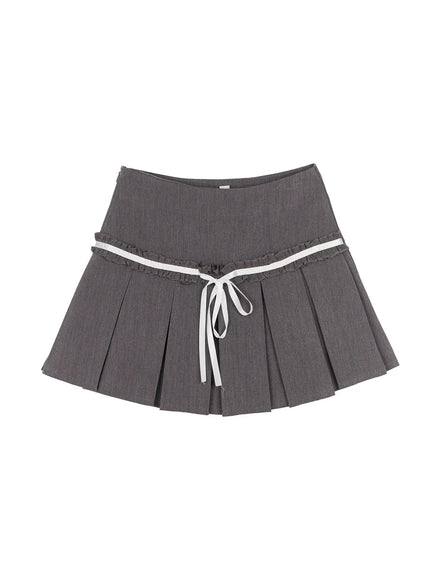 High-Waist Bow Pleated Skirt IL506 Dark gray flat-lay front view showing high waistband, double ruffle trim, white satin ribbon bow tie, and box pleats