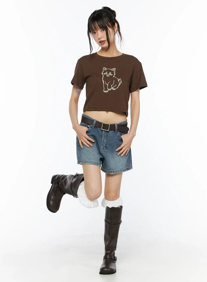 High-Waist Denim Jorts CU530 Dark blue full-body front shot on model in playful one-leg-raised pose styled with brown crop tee and leather boots