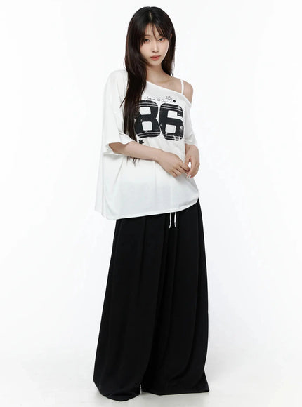 High-Waist Lace Wide Leg Sweatpants IL506 Black full-body front model shot styled with white off-shoulder 86 graphic tee hands at sides standing pose