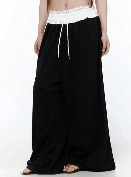 High-Waist Lace Wide Leg Sweatpants IL506 Black front model shot cropped waist-down slightly angled showing lace waistband white drawstring and wide-leg silhouette