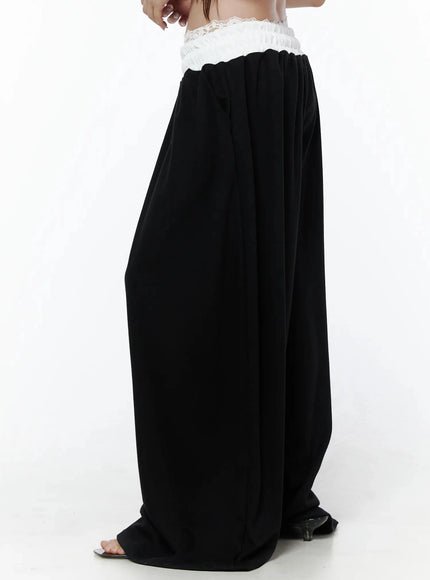 High-Waist Lace Wide Leg Sweatpants IL506 Black side model shot waist-down cropped showing lace waistband volume and drape of wide-leg silhouette