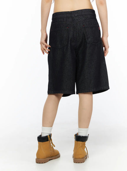 High-Waist Pintuck Jorts CU530 black back shot on model showing wide-leg silhouette dual back pockets and red tab label with tan boots