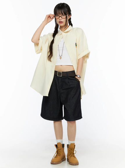 LEWKIN High-Waist Pintuck Jorts CU530 black full outfit front shot on model wearing cream oversized shirt and tan boots
