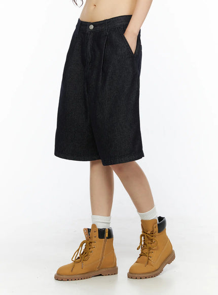 High-Waist Pintuck Jorts CU530 black side shot on model with hand in pocket styled with white socks and tan lace-up boots