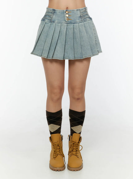 High-Waist Pleated Denim Mini Skirt CU529 Light blue front view on model size M with pleated skirt and gold buttons styled with tan boots