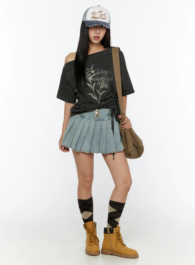 High-Waist Pleated Denim Mini Skirt CU529 Light blue full-body outfit shot model in cap and graphic tee with shoulder bag