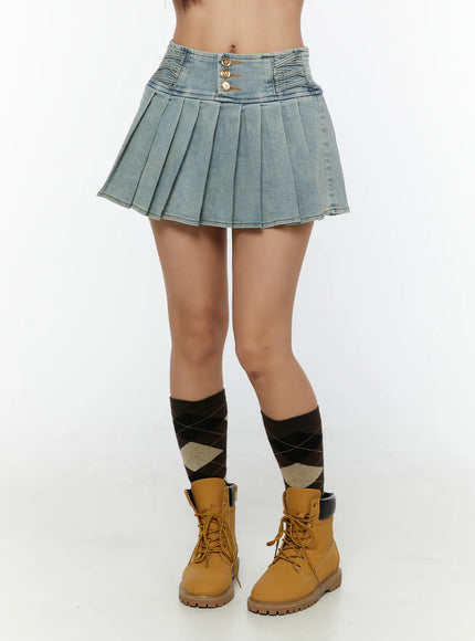 LEWKIN High-Waist Pleated Denim Mini Skirt CU529 Light blue front view on model wearing tan boots and argyle socks