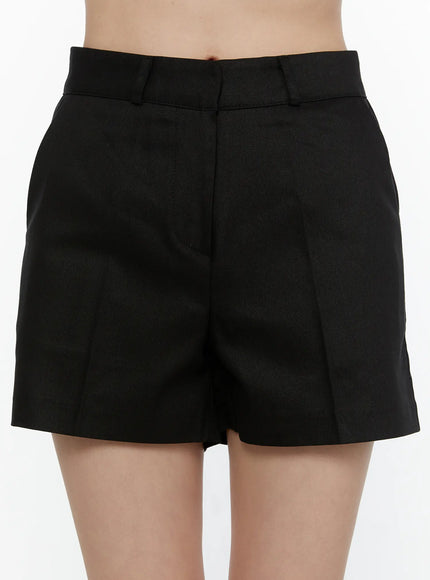 High-Waist Tailored Shorts CL521 black close-up front detail shot on model showing high waist, belt loops, and twill fabric texture