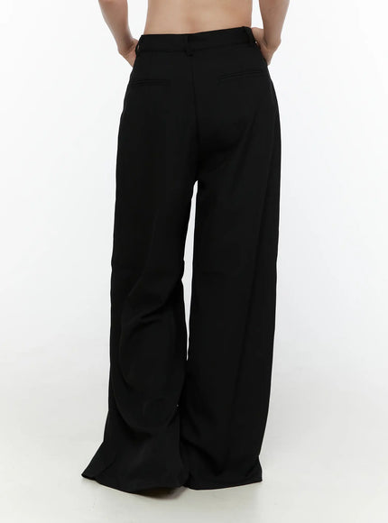 High-Waist Wide Leg Tailored Pants (Black) CL520 Black back full-length shot on model wearing grey ribbed top, holding black bag, showing back waistband and wide-leg fall