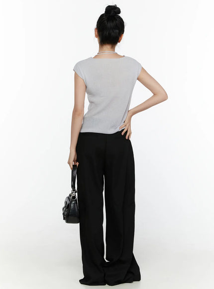 High-Waist Wide Leg Tailored Pants (Black) CL520 Black front three-quarter view on model with hand on hip, highlighting asymmetric waist cut and extra-wide leg with black ballet flats