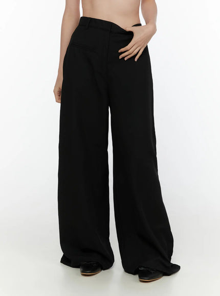 High-Waist Wide Leg Tailored Pants (Black) CL520 Black side three-quarter close-up on model showing high-rise waistband, side pocket, and voluminous wide-leg trouser drape
