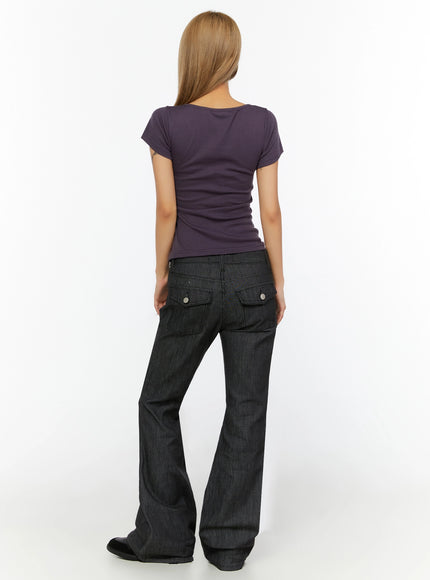 Hina No-Fade Bootcut Flared Jeans IL524 Black back shot on model in purple graphic tee revealing snap-button back pockets and wide flared hem