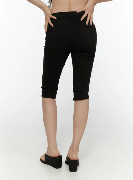 Hip-Pad Capri Pants CL507 Black back view on model showing rear pockets slim capri fit cuffed hem styled with floral top and crossbody bag
