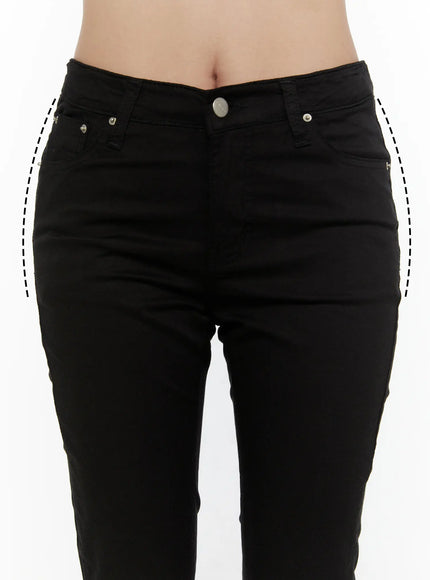 Hip-Pad Capri Pants CL507 Black close-up front waist detail on model showing low-rise silver button fly coin pockets and dashed hip-pad outline