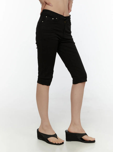 Hip-Pad Capri Pants CL507 Black side view on model showing slim capri silhouette zip fly silver rivets cuffed hem and wedge sandals