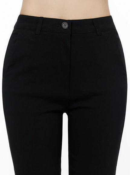 Hip-Pad Capri Slacks IU525 Black close-up detail of waistband and button closure on model, showing high-rise fit and smooth fabric texture