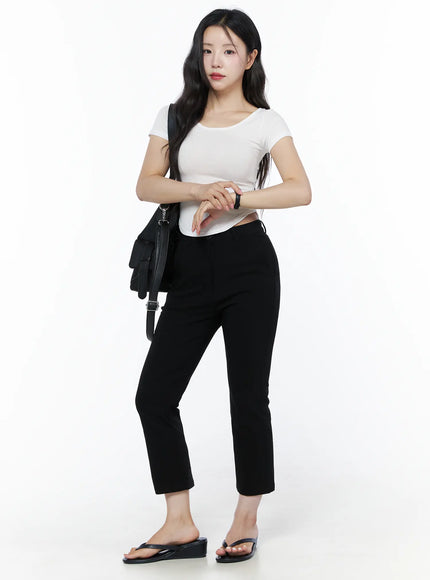 Hip-Pad Capri Slacks IU525 Black front view on model with black crossbody bag, white crop top, hands clasped, black wedge flip-flop sandals