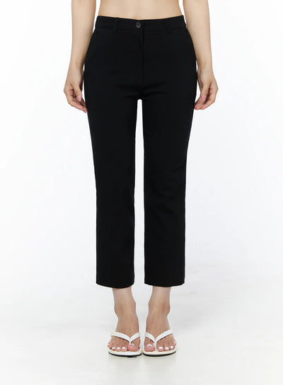 LEWKIN Hip-Pad Capri Slacks IU525 Black front view on model, cropped straight-leg trousers with button closure, styled with white crop top and white sandals