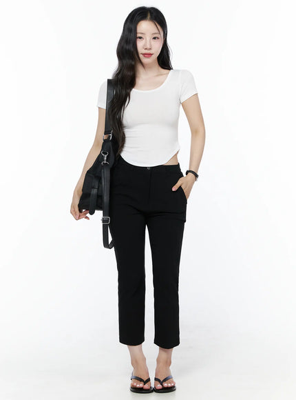 Hip-Pad Capri Slacks IU525 Black full-length front view on model with black leather shoulder bag, white crop top, and black flip-flop sandals