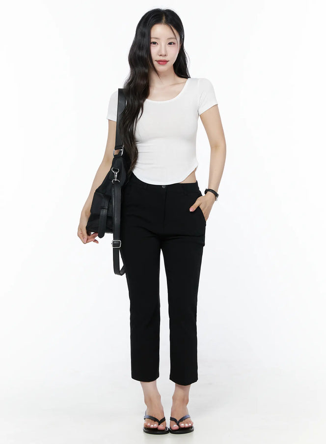 Hip-Pad Capri Slacks IU525 Black full-length front view on model with black leather shoulder bag, white crop top, and black flip-flop sandals