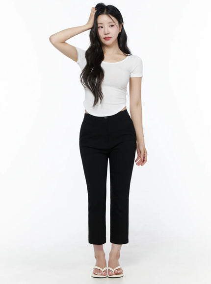 Hip-Pad Capri Slacks IU525 Black full-length front view on model with hand raised, white crop top, cropped straight-leg silhouette with white heeled sandals