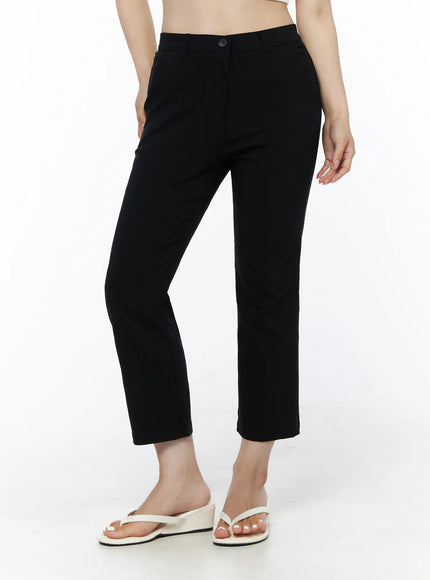 Hip-Pad Capri Slacks IU525 Black angled front view on model showing side pocket and button fly detail, styled with white crop top and white wedge sandals