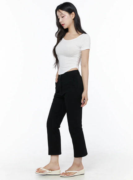 Hip-Pad Capri Slacks IU525 Black side view on model looking down, cropped straight-leg silhouette with high waistband, paired with white crop top and white sandals