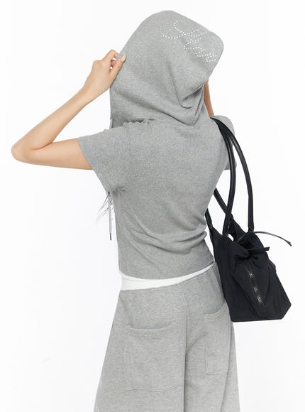 Hooded Short Sleeve Zip-Up IL515 Gray back view on model lifting hood to reveal white star print detail with black bag