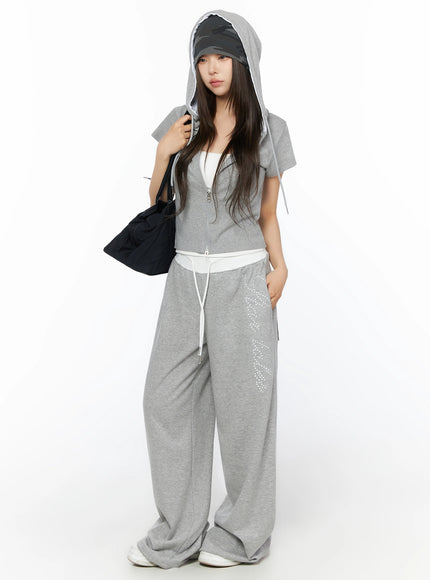LEWKIN Hooded Short Sleeve Zip-Up IL515 Gray S/M front view on model wearing hood up with black bag and wide-leg sweatpants