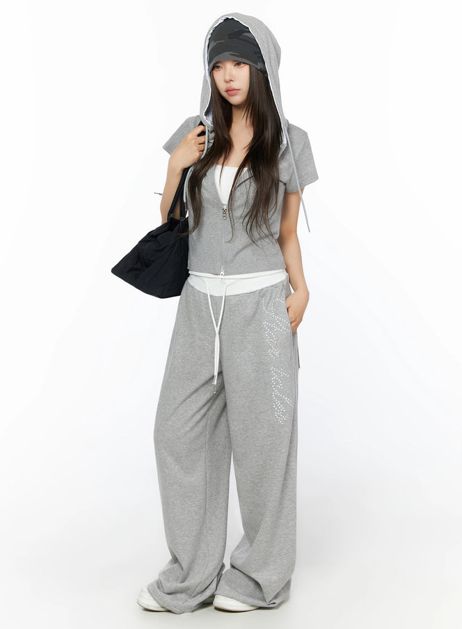 LEWKIN Hooded Short Sleeve Zip-Up IL515 Gray S/M front view on model wearing hood up with black bag and wide-leg sweatpants