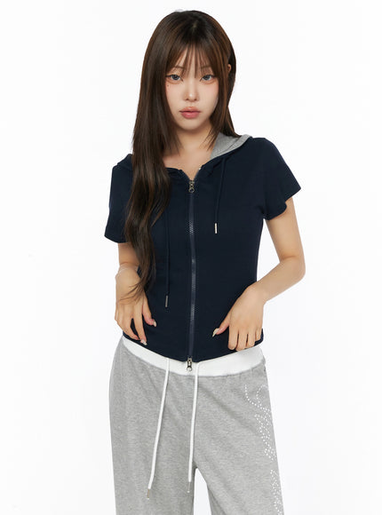 Hooded Short Sleeve Zip-Up IL515 Navy front view on model with zip closure and gray hood contrast lining styled with gray sweatpants