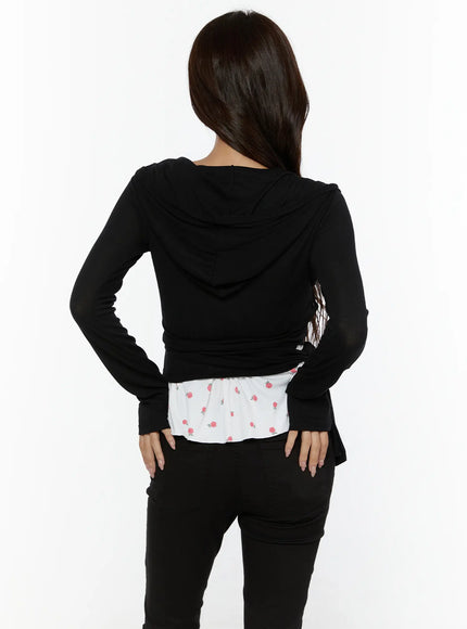Hooded Wrap Crop Cardigan CL507 Black back shot on model showing hood, wrap back construction, floral ruffle hem peeking below, styled with black jeans