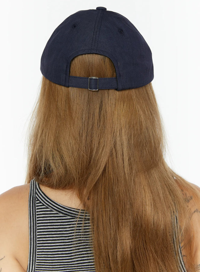 Index Cotton Ball Cap IL503 Navy back view on model with long hair, silver adjustable buckle strap detail visible at rear