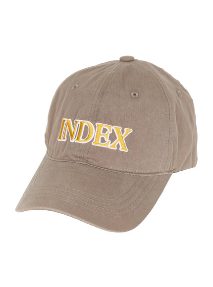 Index Cotton Ball Cap IL503 Beige angled product shot on white background, gold and white INDEX embroidery on front panel, unstructured cotton twill dad cap silhouette