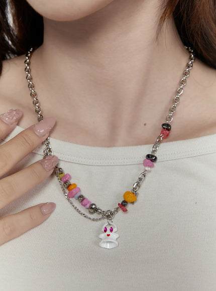 Iris Color Stone Necklace IL517 silver front model neck shot worn over white top featuring ghost charm colorful stone beads and layered silver chain