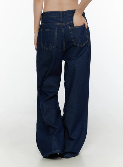 Jael Dark Washed Wide Leg Jeans CL520 Dark blue back close-up on model showing dual back patch pockets with yellow topstitching and relaxed wide-leg denim cut
