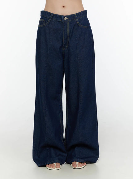 Jael Dark Washed Wide Leg Jeans CL520 Dark blue full-length front view on model showing complete wide-leg silhouette, center crease seam, low-rise waist, and white strap sandals
