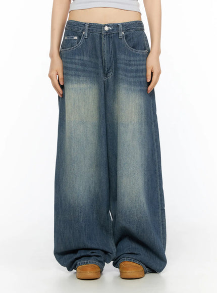 LEWKIN Jesse Vintage Wash Wide Leg Jeans CU530 Blue front view on model size S, cropped midriff pose, washed indigo wide-leg denim with faded whisker detail