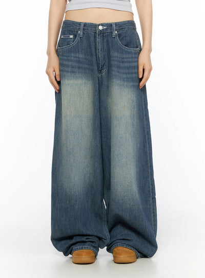 LEWKIN Jesse Vintage Wash Wide Leg Jeans CU530 Blue front view on model size S, cropped midriff pose, washed indigo wide-leg denim with faded whisker detail